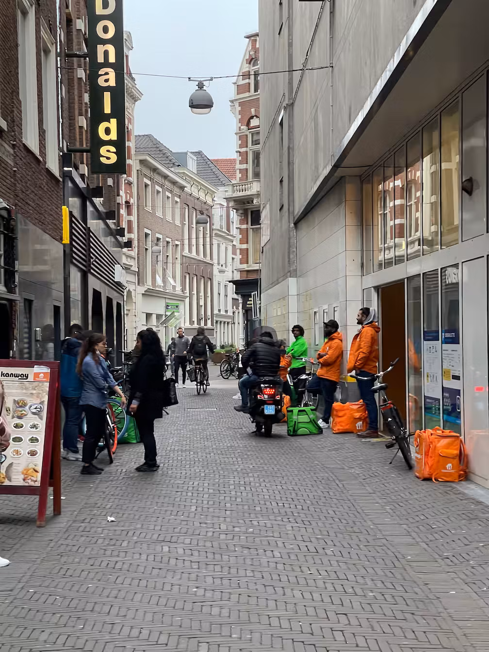 delivery people waiting for their orders in front of a mcdonalds
